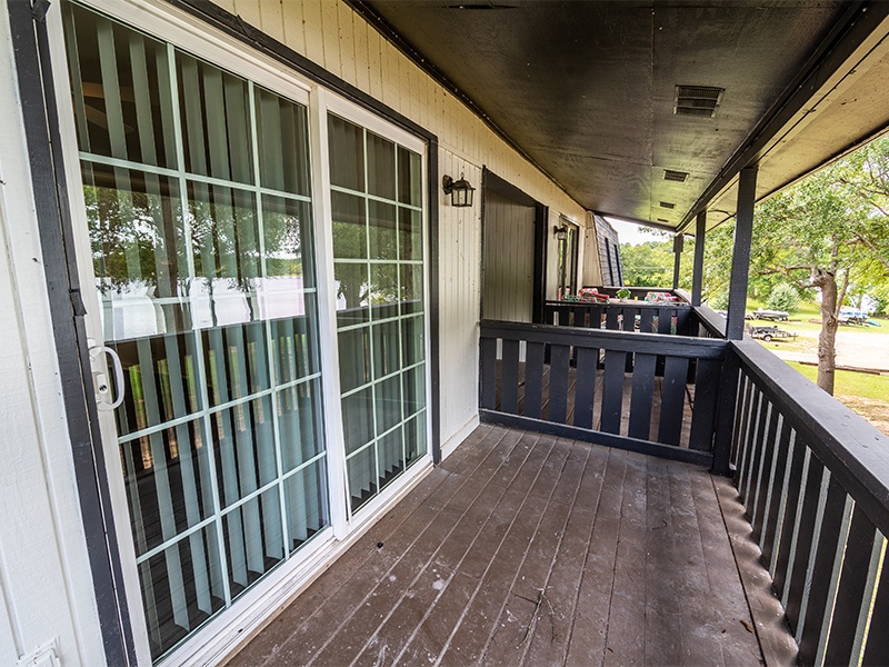 A wooden deck with a sliding glass door.